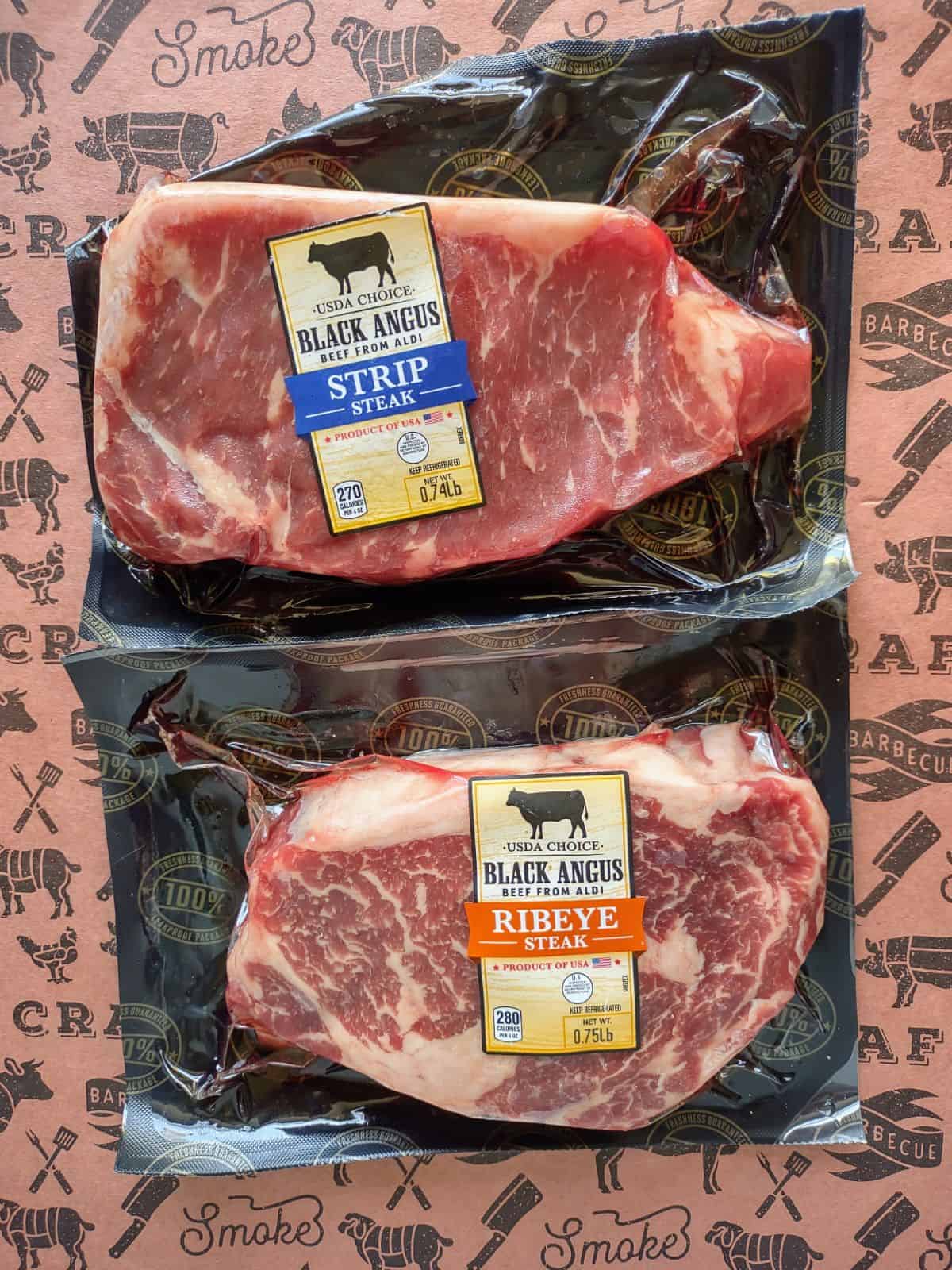 Black Angus Choice Strip steak and Ribeye steak from ALDI on butcher paper.