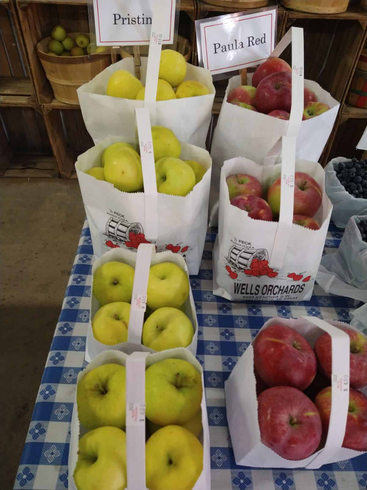 Bags of Pristine and Paula Red apples. 