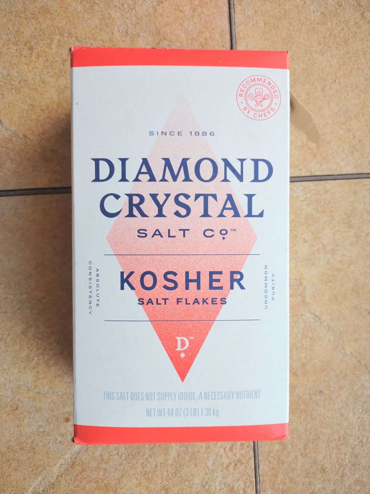 A box of Diamond Crystal Kosher Salt Flakes on a table.