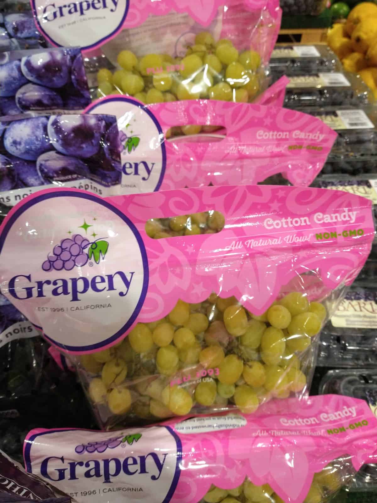 Bags of Cotton Candy grapes at a store.