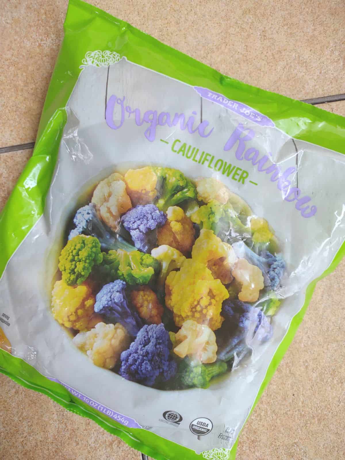 A bag of Trader Joe's Organic Rainbow Cauliflower on a table.