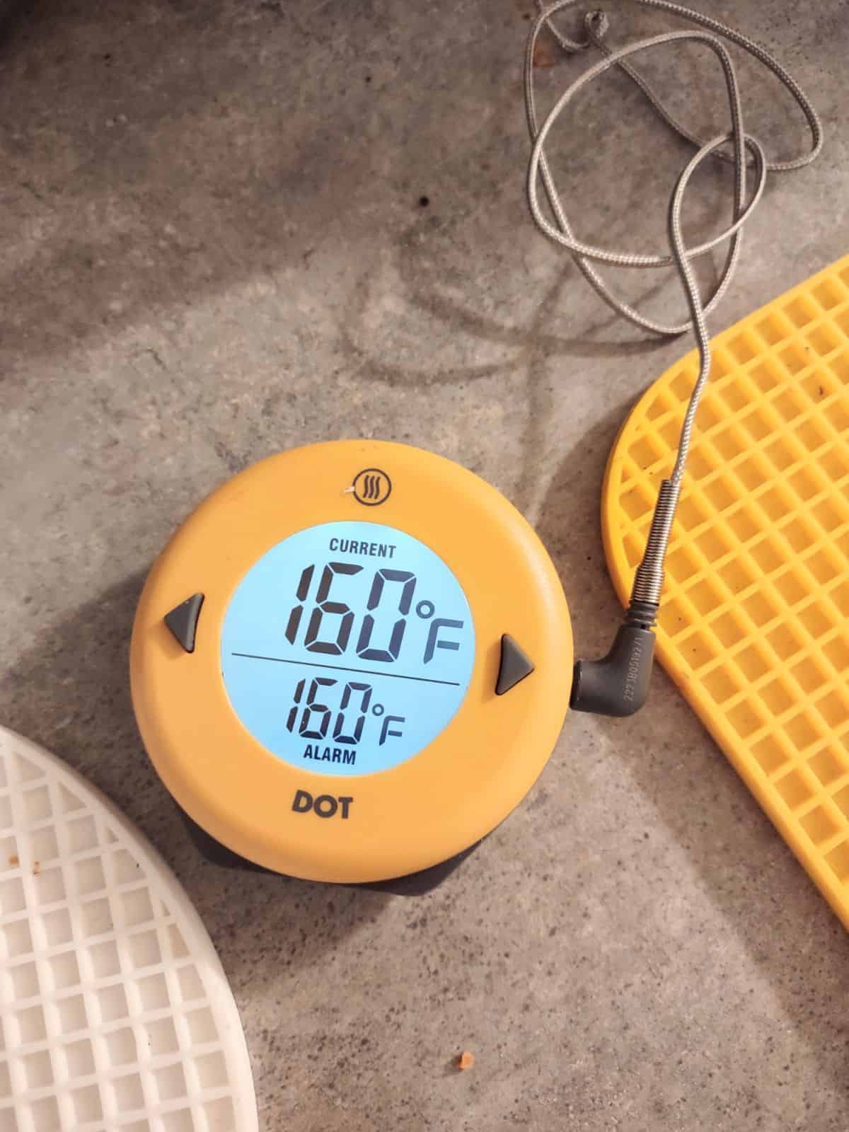 A yellow ThermoWorks DOT Simple Alarm Thermometer set to 160 degrees.