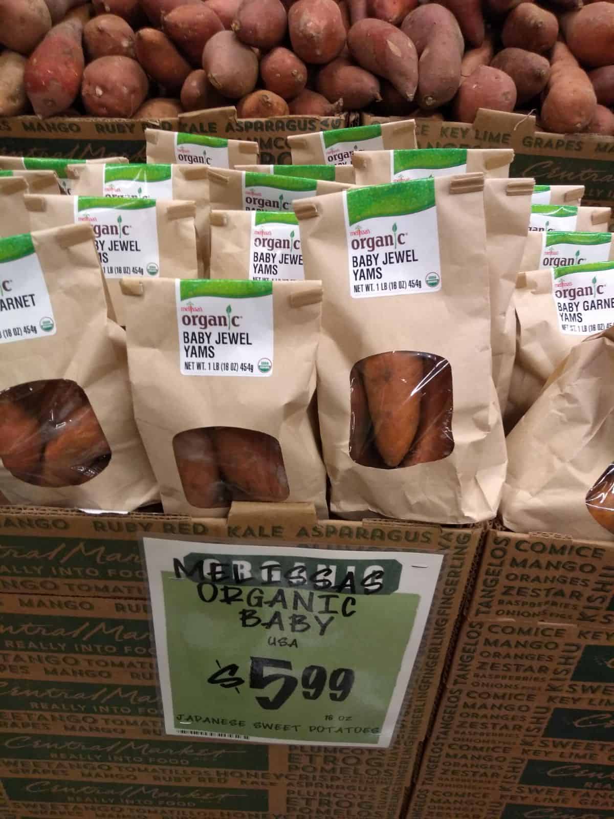 Small bags of Melissa's Organic Baby Jewel Potatoes on display.