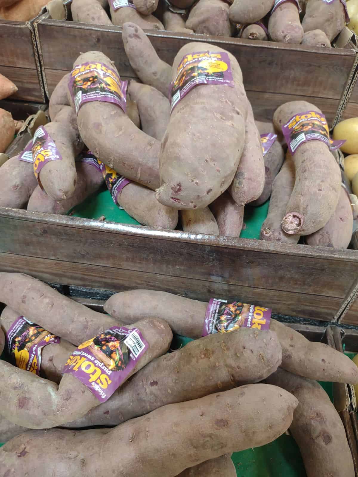 Stokes Purple Sweet Potatoes on display at a Sprouts store.
