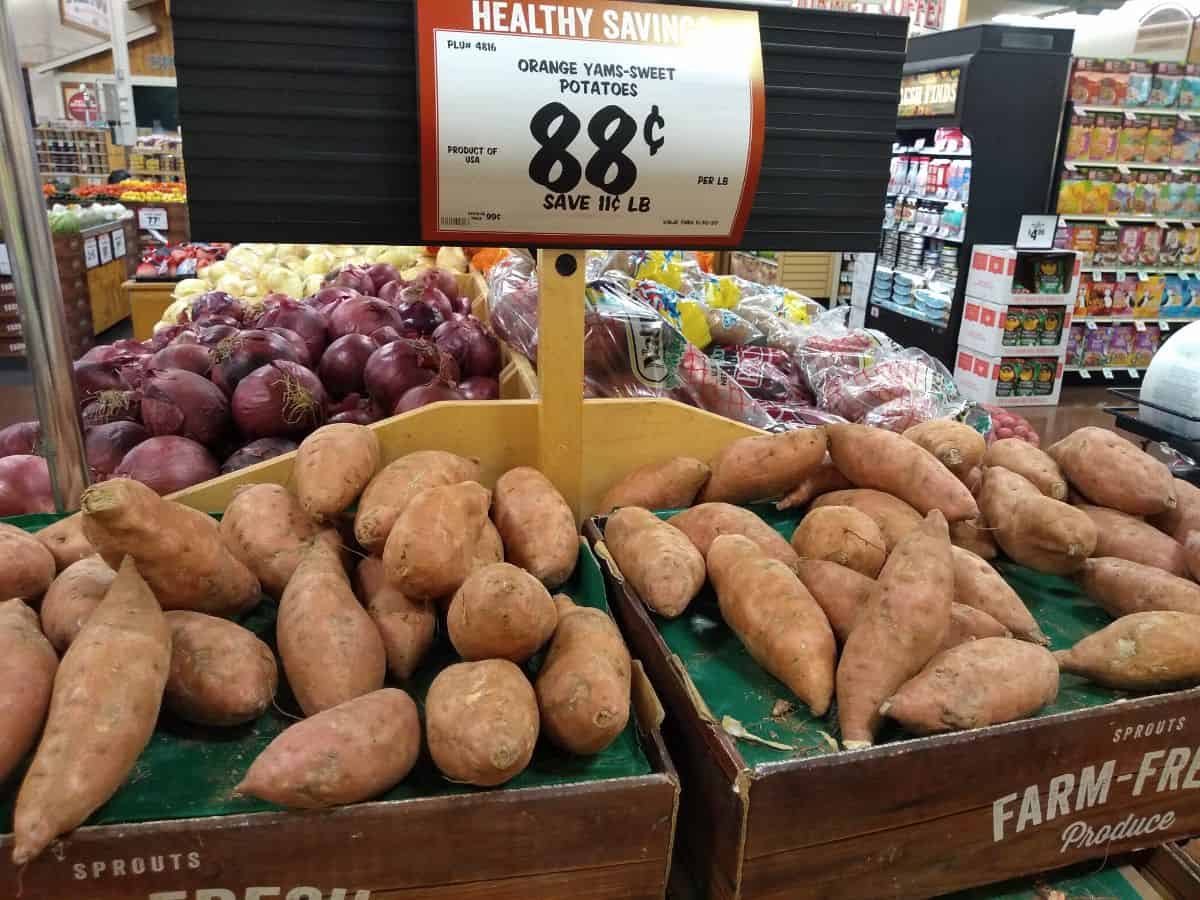 Sprouts display of sweet potatoes that is labelled as "orange yams-sweet potatoes".