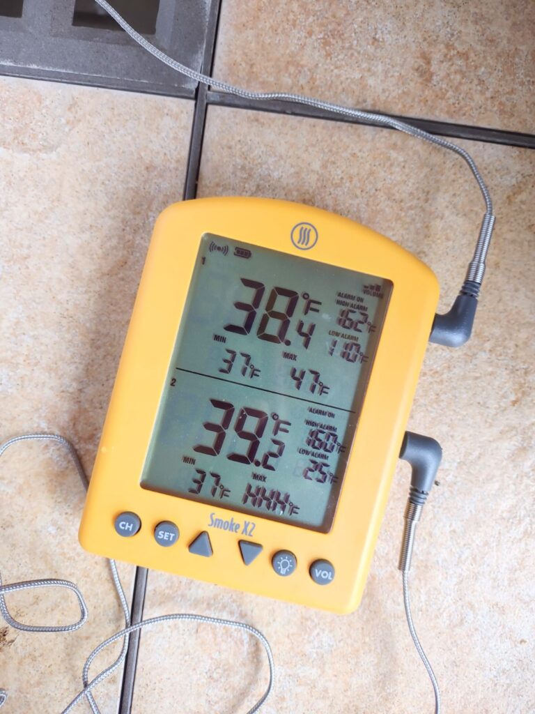 A ThermoWorks Smoke X2 thermometer on a table showing that it's below 40 degrees outside.