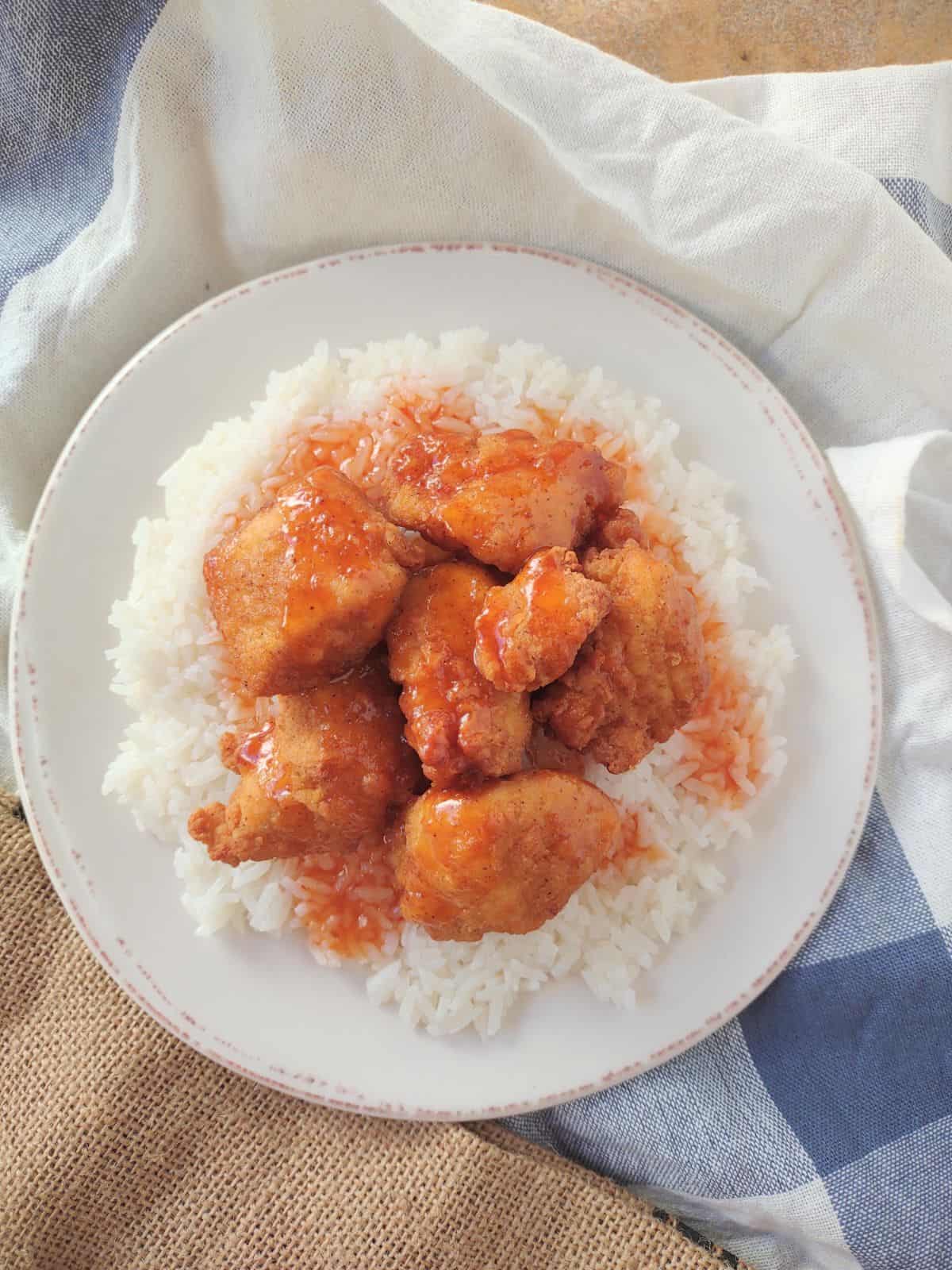 Kirkland Lightly Breaded Chicken Breast Chunks over top of white Jasmine rice and topped with a sweet & sour sauce.