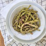 Chinese long beans in a bowl with sesame seeds