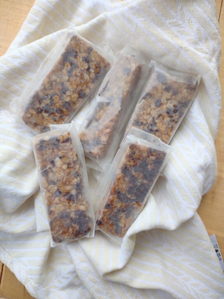 Tahini Chocolate Chip granola bars wrapped in wax paper.