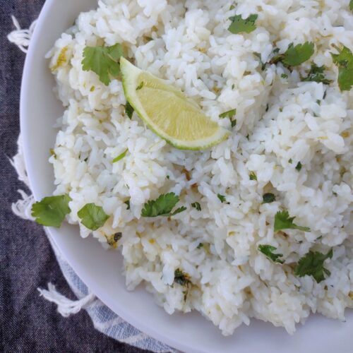 White rice with cilantro and lime in a white bowl