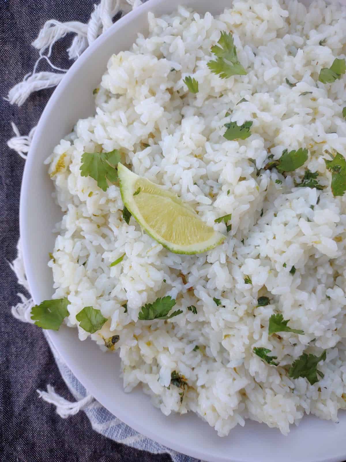 White rice with cilantro and lime in a white bowl