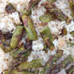 A close up of rice pilaf with asparagus.