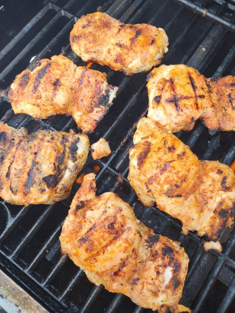 Dry rubbed chicken thighs on the grill.