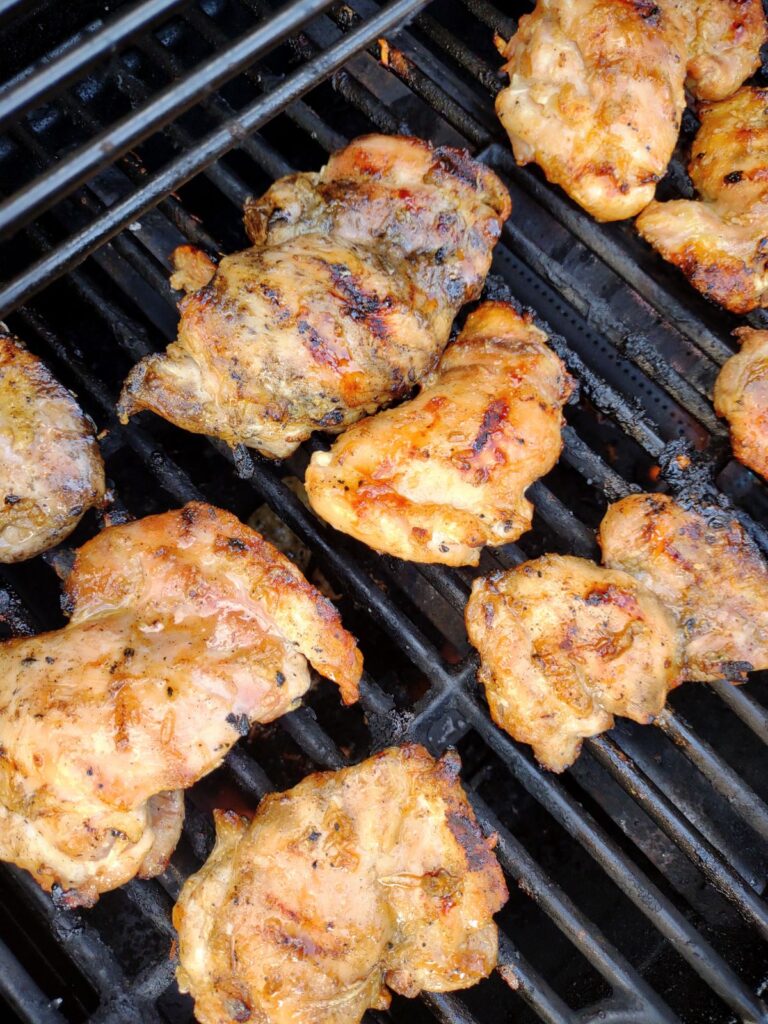 Honey Garlic & Ginger Grilled Chicken Thighs on the grill.