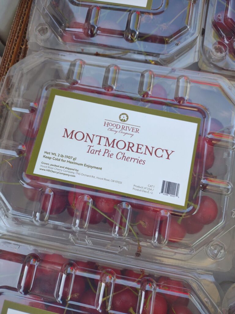 A plastic clam shell container filled with Montmorency Tart Pie cherries from Hood River, Oregon