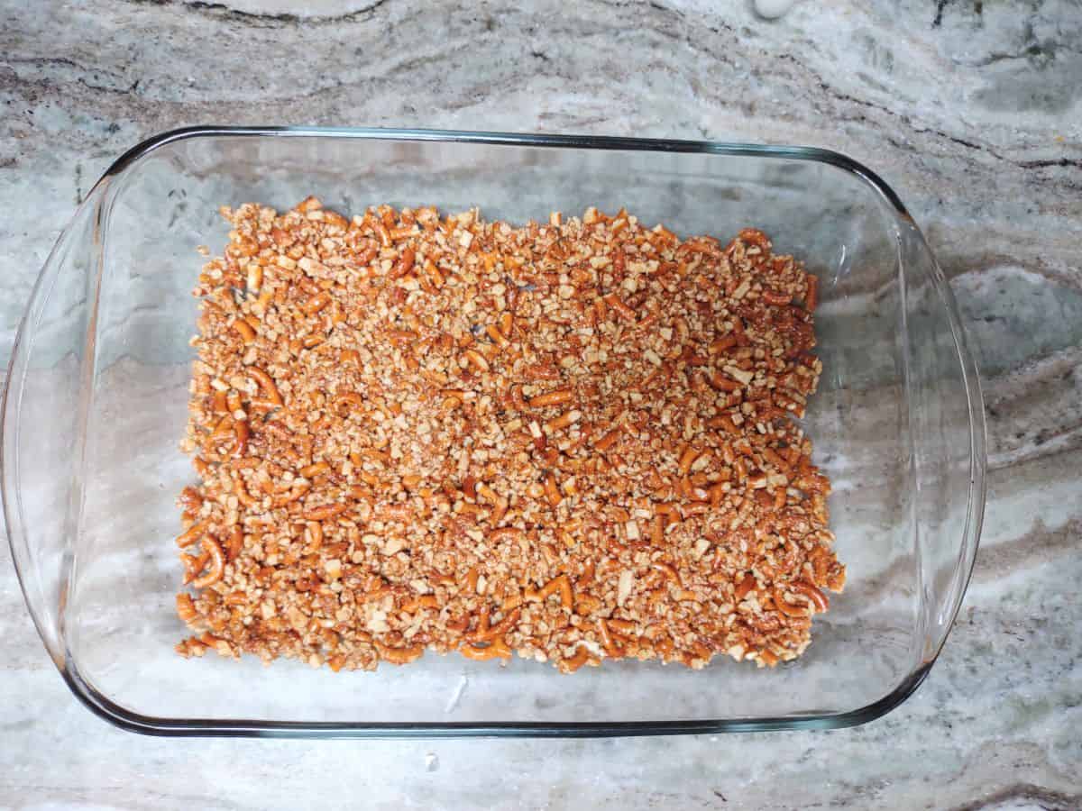 Pretzel crust in a glass baking dish.