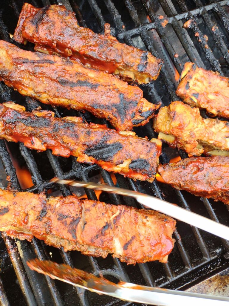 St Louis Pork Ribs portion being finished on the grill.