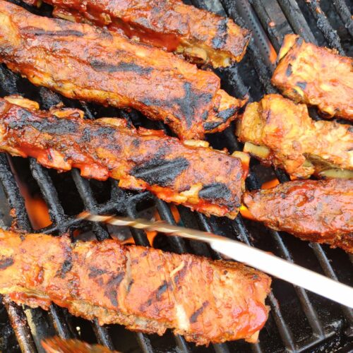 St Louis Pork Ribs portion being finished on the grill.