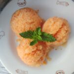 3 scoops of peach granita on a white plate