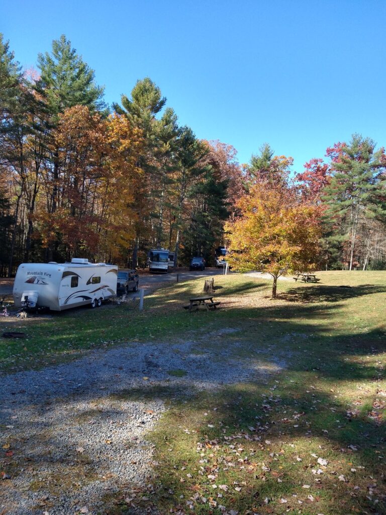 A camper at a campground in West Virginia in the fall during peak leaf colors.