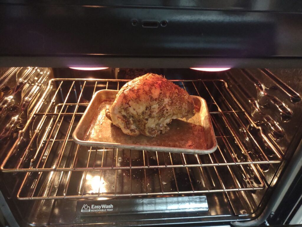 A whole bone-in turkey breast that was cooked in the Instant Pot is getting browned in the oven on broil.