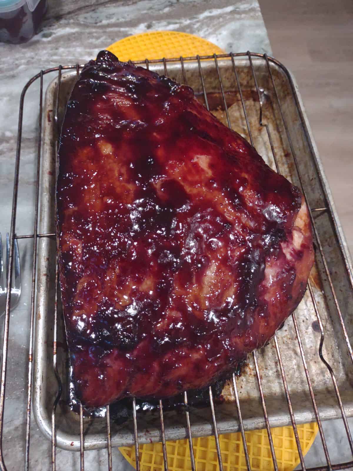 A blackberry glazed Kirkland Master Carve ham finished on a sheet pan.