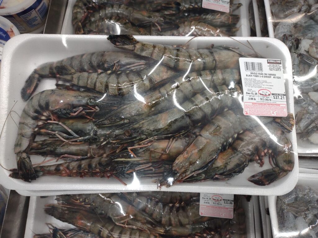 A package of Whole Head-On Farmed raised Black tiger shrimp on display at Costco in 2025.