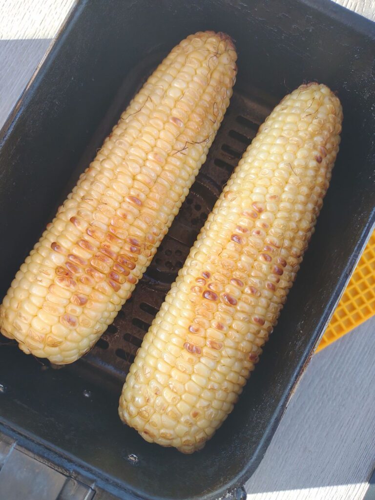 Corn that has been cooked in an air fryer and has some browned kernels.