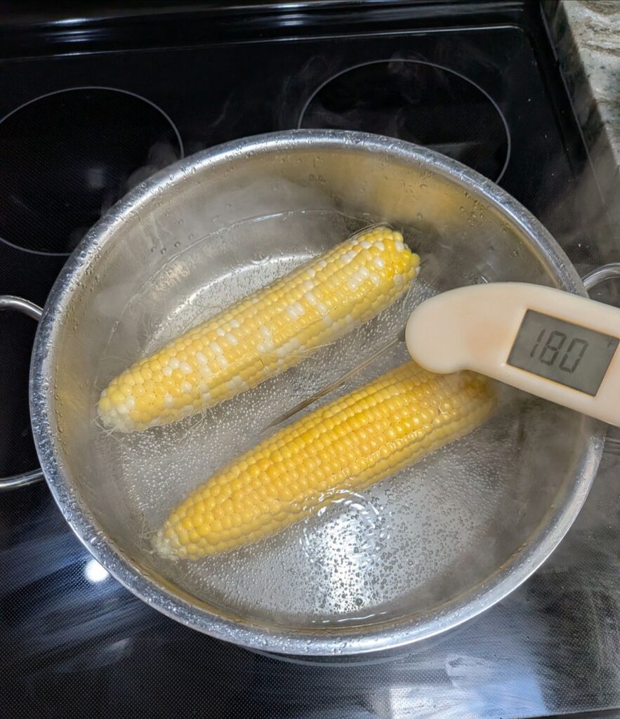 Corn on the cob in a pot of water that has reached 180°F