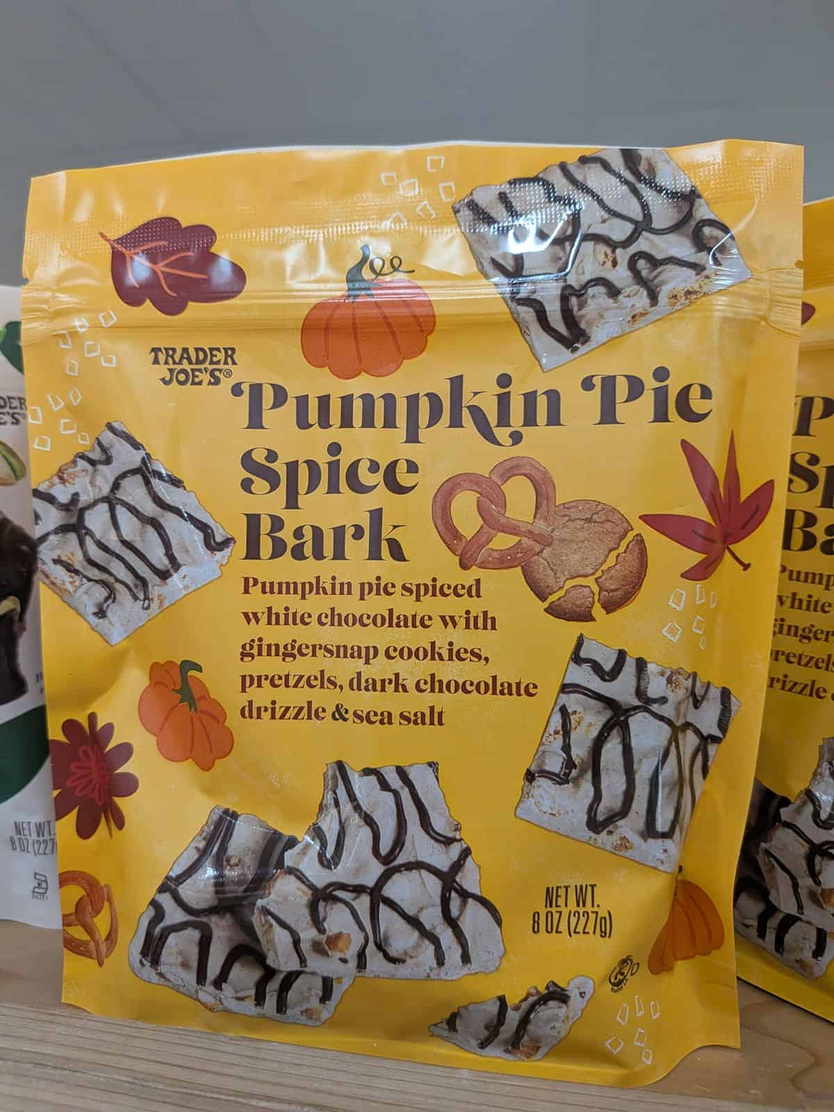 Bags of Trader Joe's Pumpkin Pie Spice Bark, which is pumpkin pie spiced white chocolate with gingersnap cookies, pretzels, dark chocolate drizzle, and sea salt.